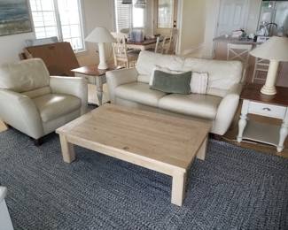 Cream leather sofa with two matching chairs. Two end tables with matching lamps. One coffee table