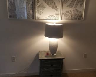 Nightstand matches tall dresser. Table lamp; artwork