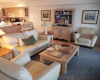 Cream leather sofa with two matching chairs. Two end tables with matching lamps. One coffee table