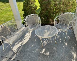 White wrought iron chairs, table and bench.