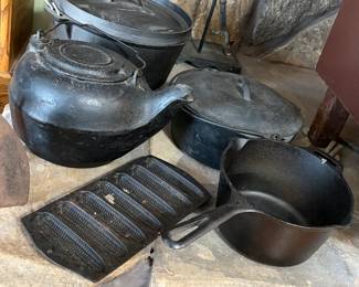 Vintage iron pots and pans. There are more iron skillets to choose from along with these.