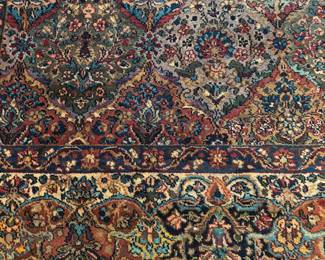 DETAIL OF 10 BY 14 AREA RUG BY KARASTAN
