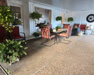 Patio table with 4 chairs and umbrella that matches the chair cushions, 4 extra chairs with cushions, bench, firepit, hanging plants, Texas star