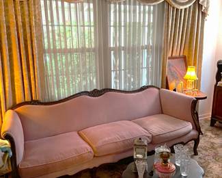 In the living room this fairly ornate sofa and coffee table sits, waiting for you to come test it out.