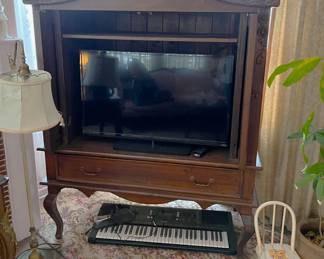 This picture shows the keyboard (not sure of the brand), as well as a larger television.