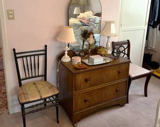 More sets of drawers are shown here, along with two wooden chairs.