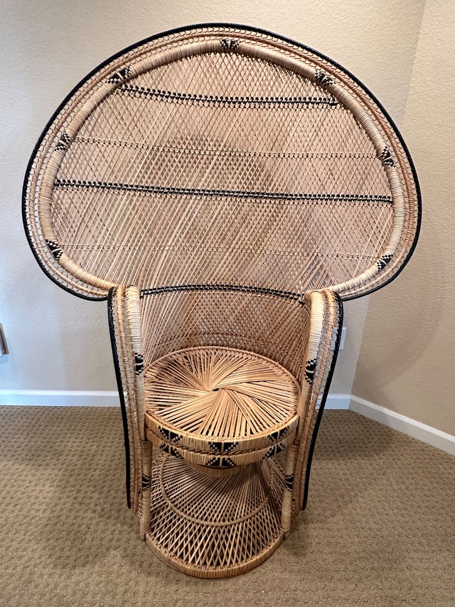 Mid-Century Peacock Chair
This striking mid-century rattan peacock chair features an elaborate fan-back design with intricate woven details, evoking timeless bohemian elegance.