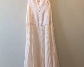 Another view of the Carmela Lu Tera strapless white dress, fitted bodice with pleated chiffon skirt
