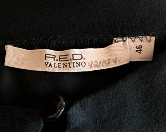 Closeup of R.E.D. Valentino black silk blouse with rhinestone accents, size 46