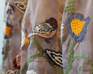 Closeup of Anthropologie strapless beaded embroidered birds dress
