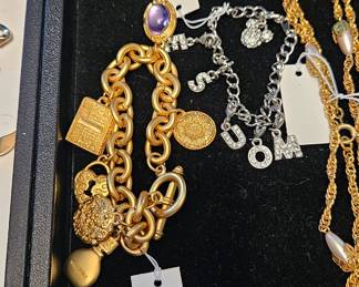 A Mickey Mouse charm bracelet and a Gloria Vanderbilt gold tone charm bracelet
