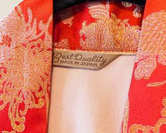 Closeup of the gorgeous red silk gold chrysanthemum pattern haori kimono jacket, made in Japan