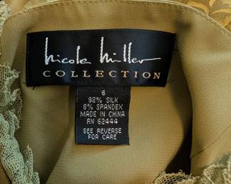 Closeup of vintage Nicole Miller Collection gold silk cocktail dress with spaghetti straps, size 6