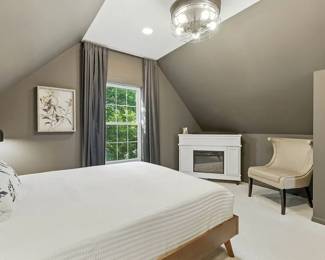Bedroom furniture available including wooden bed frames, a cream-color upholstered loveseat, night lighting