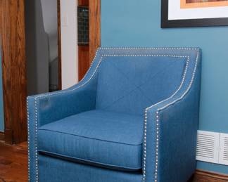 A modernist style blue upholstered arm chair / accent chair with silver nail head trim