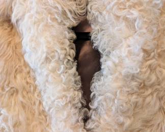 Closeup of cream color lamb fur coat