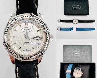 A Lois Hill round white filigree scroll sport watch with screw down crown and rotating bezel, black leather band and separate blue leather band, in original packaging