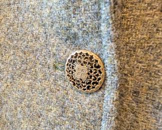 Closeup of women's light brown blazer with vintage decorative buttons