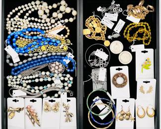 Fabulous vintage costume jewelry including a Mickey Mouse charm bracelet, a Gloria Vanderbilt charm bracelet, a vintage "hustle burr" charm, vintage MGM Grand gambling tokens, bead necklaces, Faux pearl necklaces and more