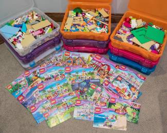 Plastic storage bins filled with vintage Lego sets, Lego Friends, Lego Disney, Lego Elves