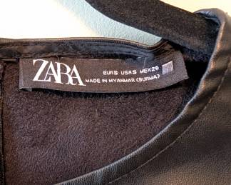 Closeup of Zara black vegan leather puff shoulder ruffle dress size S.