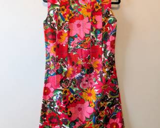 A vintage sleeveless brightly colored floral pattern mini dress
