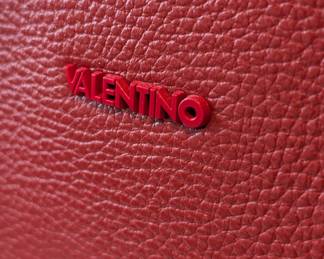 Closeup of the beautiful Valentino red leather handbag with detachable shoulder strap