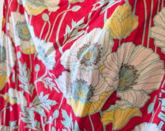 Closeup of sleeveless red summer dress with poppy pattern