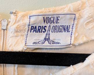 Closeup of Vogue Paris Original cream color embroidered long sleeve mini dress