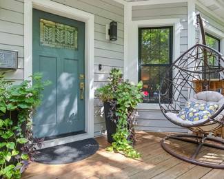 The large planters at the front door are for sale, as is the wonderfully comfy rattan brown iron frame hanging lounge chair / swing chair