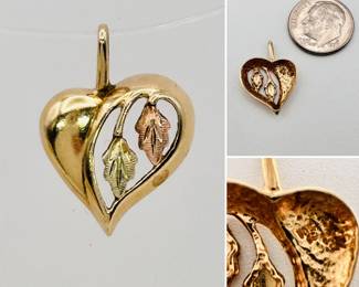 A 10k yellow gold, green gold and rose gold heart-shaped pendant