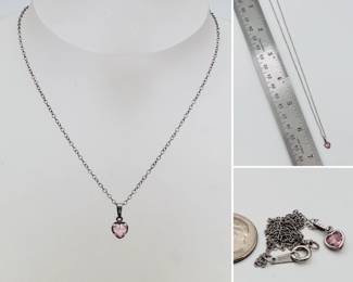 A sterling silver chain necklace with pink faceted stone pendant