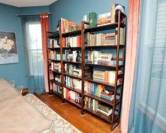 Another view of the wooden open frame bookcases, with antique and vintage books