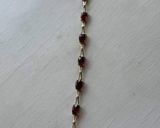 J12 - $450 - 7 1/2" long bracelet 10kt yellow gold & garnets, 7.2 gr.