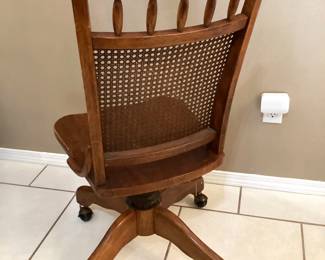 #35 - $120 - American oak desk chair, swivel, cane back.