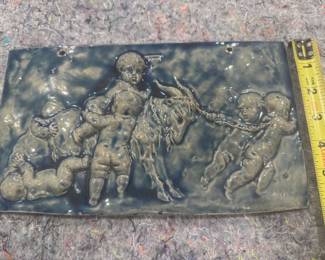 #116 - $80 - Italian grey glazed pottery tile with children pulling goat, 11x6".