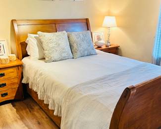 Queen Size Pine Bedroom Set with Sleigh Bed and Two Matching Side Tables.