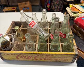 Coca Cola bottles and holder