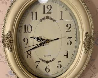 Oval framed wall clock