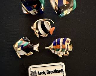 Earrings (upper) and three fish brooches