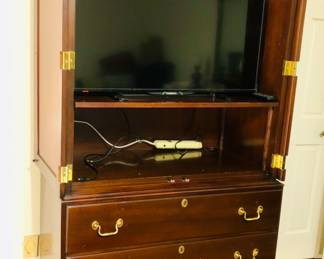 Tv armoire/chest of drawers with door open.