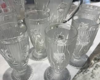 Jeanette Glass Clear Iris pitcher and glasses with other vases