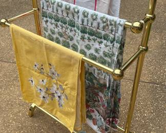 Brass towel rack & midcentury vintage table cloths 