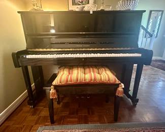 Chang upright piano in incredible condition. Finish is black lacquer, and keyboard locks down with a key lock