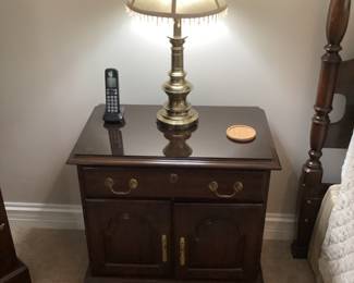 Two nightstands match the bedroom set.