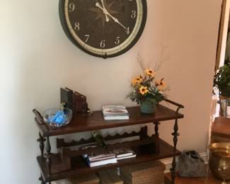 Entry shelving with large “pocket watch” style hanging clock.