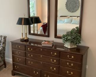 Master bedroom has a double dresser with two matching mirrors