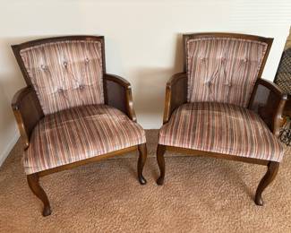 Custom upholstered arm chairs with caning on the arms