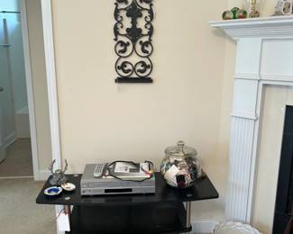tv stand, dvd player, match collection, wall art