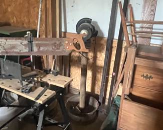 grinder, chop saw on stand, bed frame in back ground